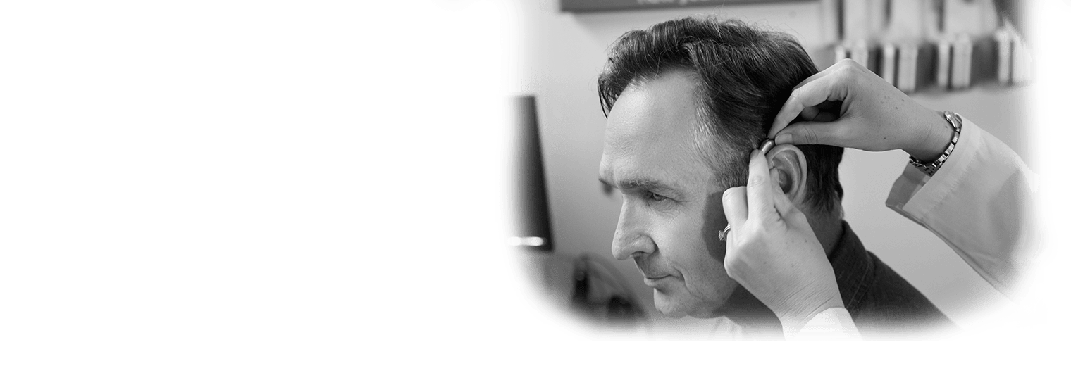 A man getting fit for hearing aids. 