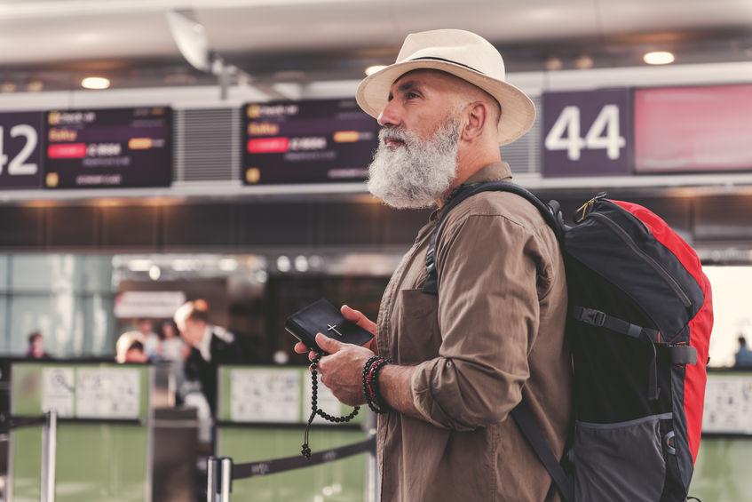 A man walks through an airport.