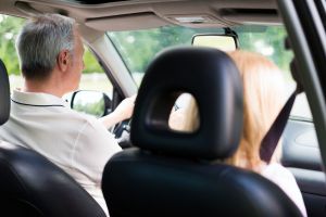 View from the backseat of a couple driving in a car