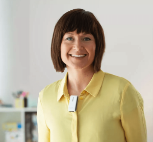 A teacher wearing a remote microphone as part of an FM/DM system.