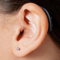 A picture of a hearing aid known as a receiver-in-the-ear hearing aid.