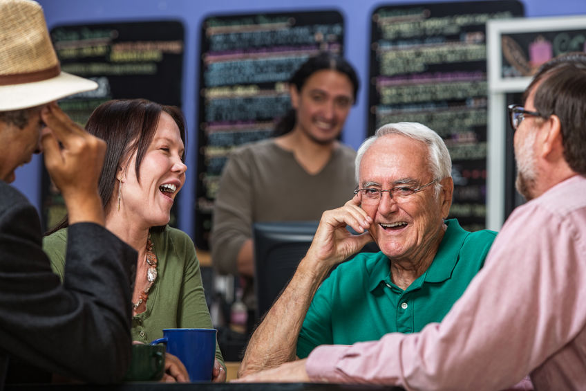 A group of people eat in a noisy restaurant. 