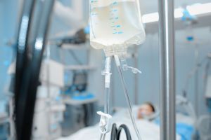 A patient receives IV antibiotics in an ICU. 