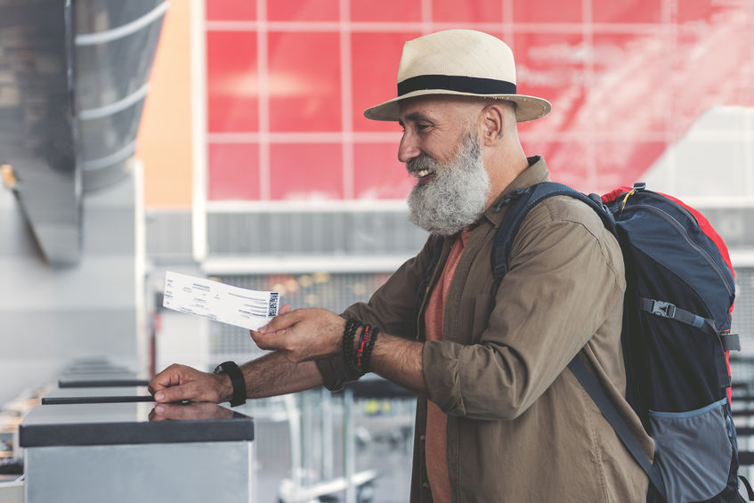 Older man checking into airport.