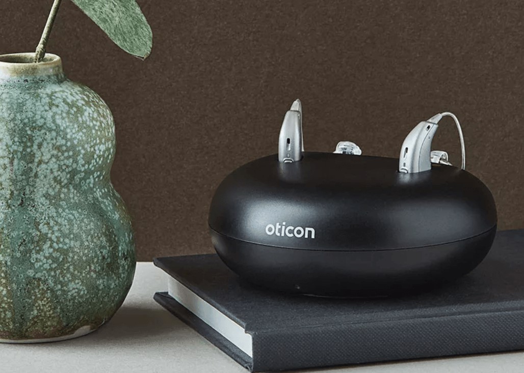 A pair of rechargeable Oticon More hearing aids. 